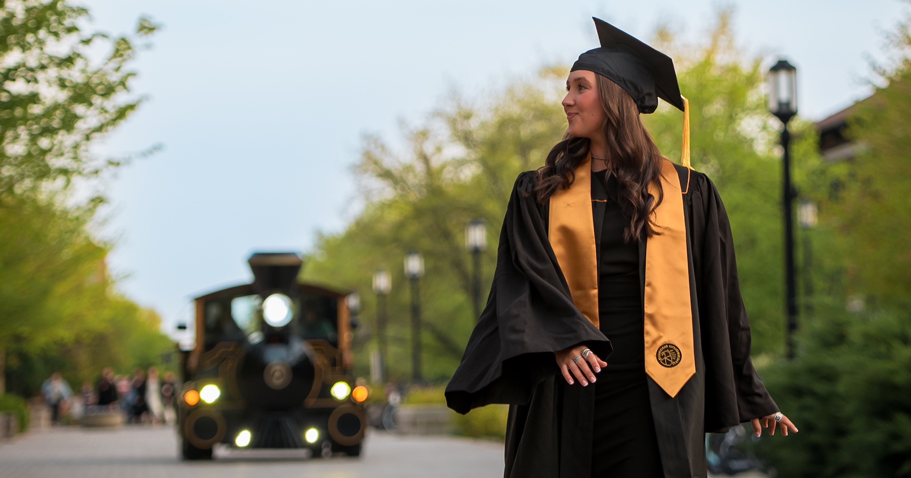 Melanie Hasler on Purdue University campus with Boilermaker special train in background