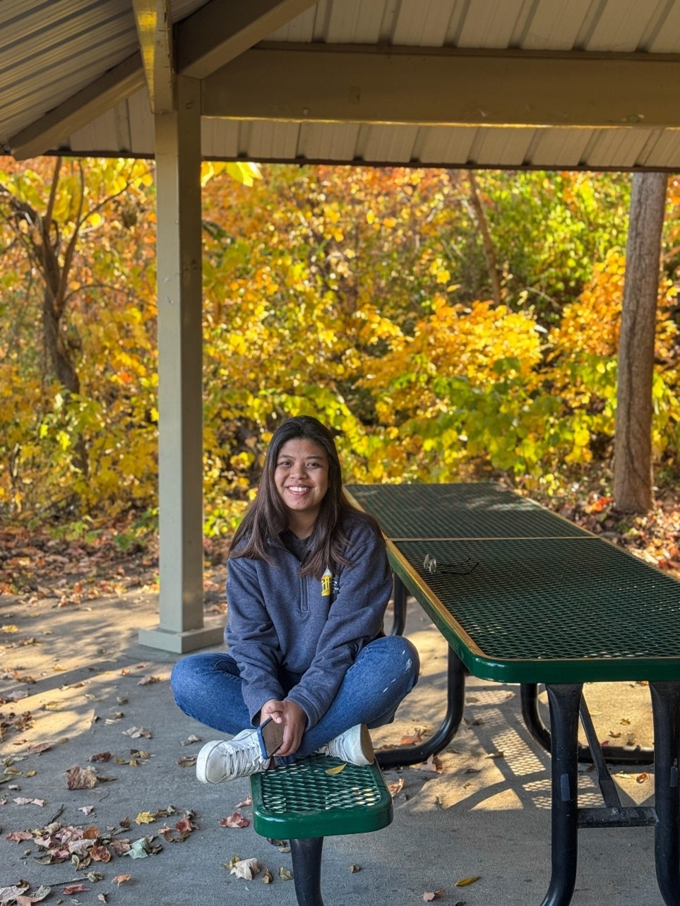 a female sitting on a park bench