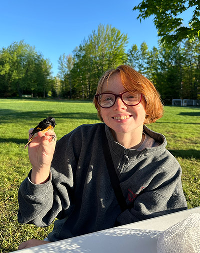 Elizabeth Nojd holds a bird